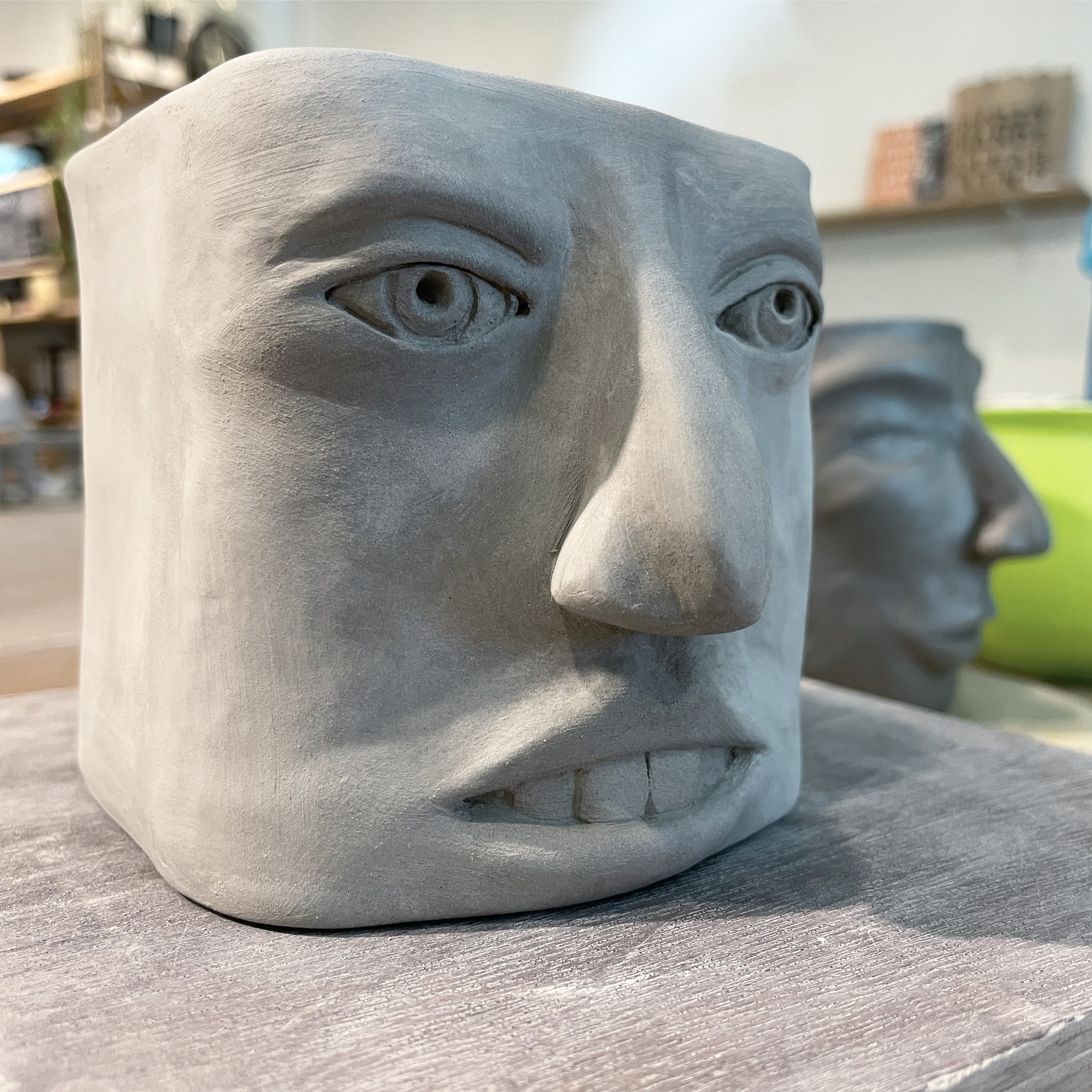 A square-shaped vessel with a face
