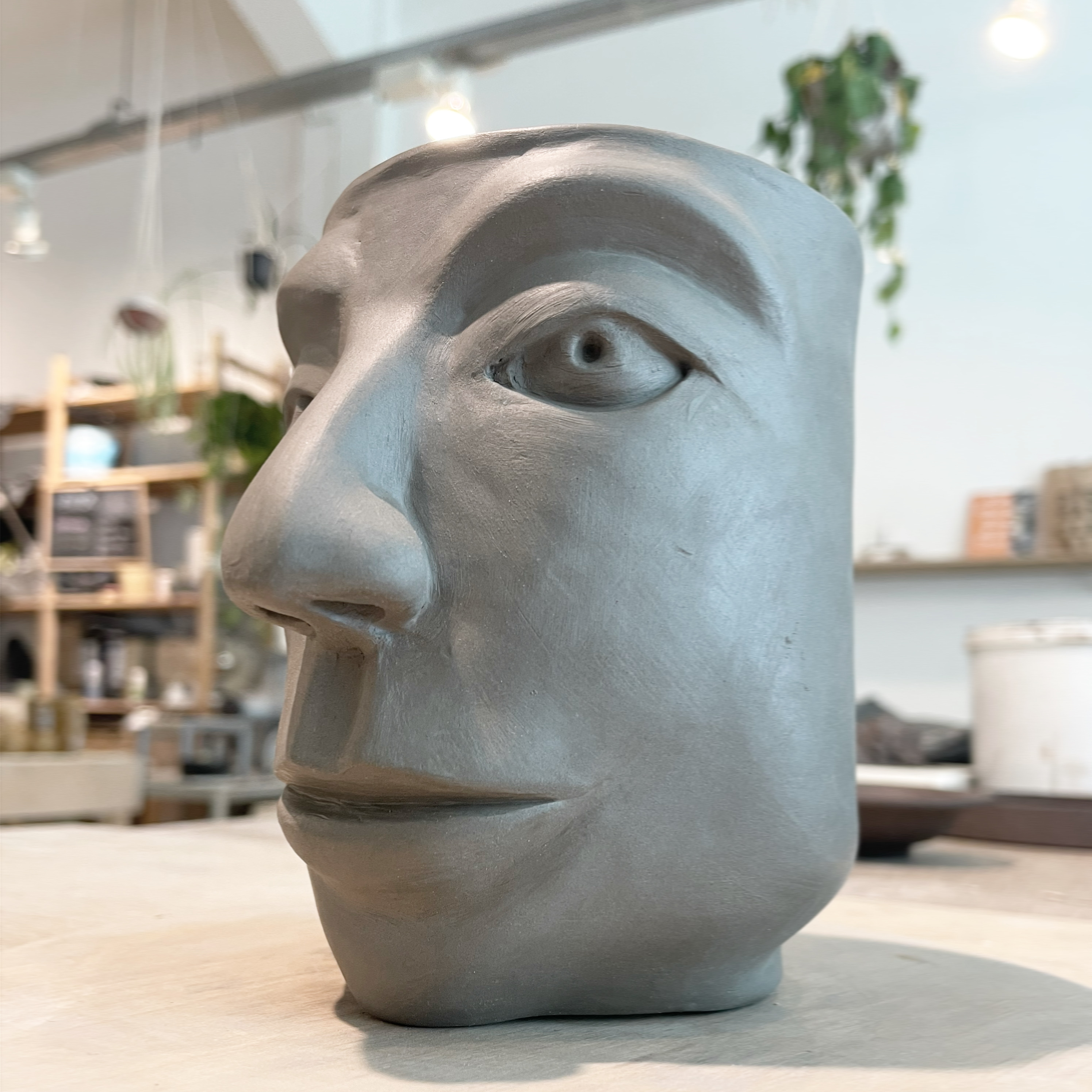 A large cup-shaped vessel with a face