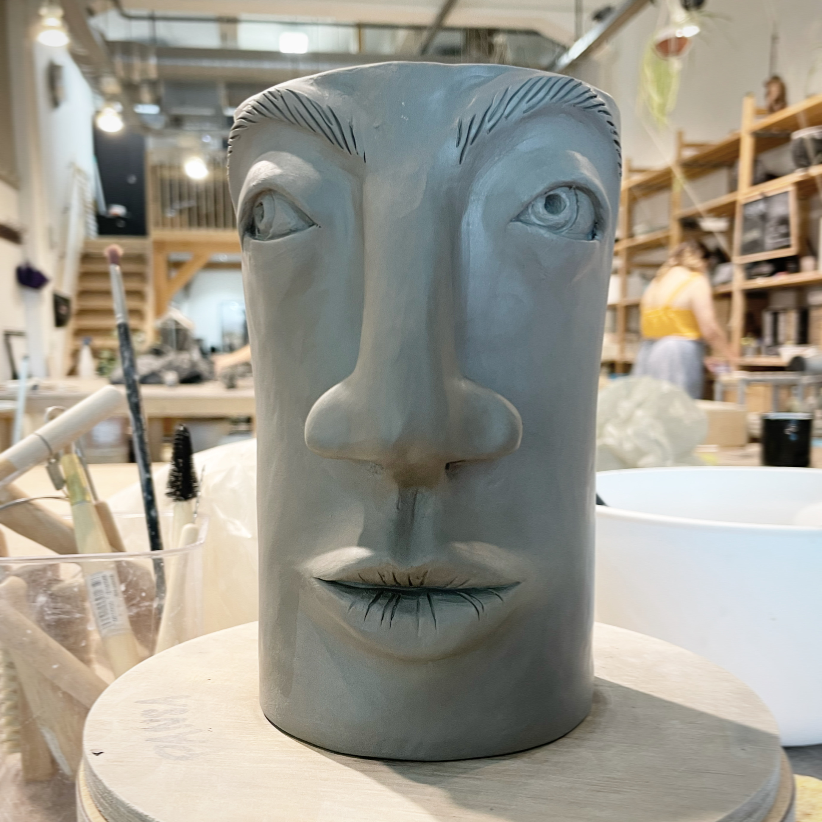 A tall tiki-shaped vessel with a face