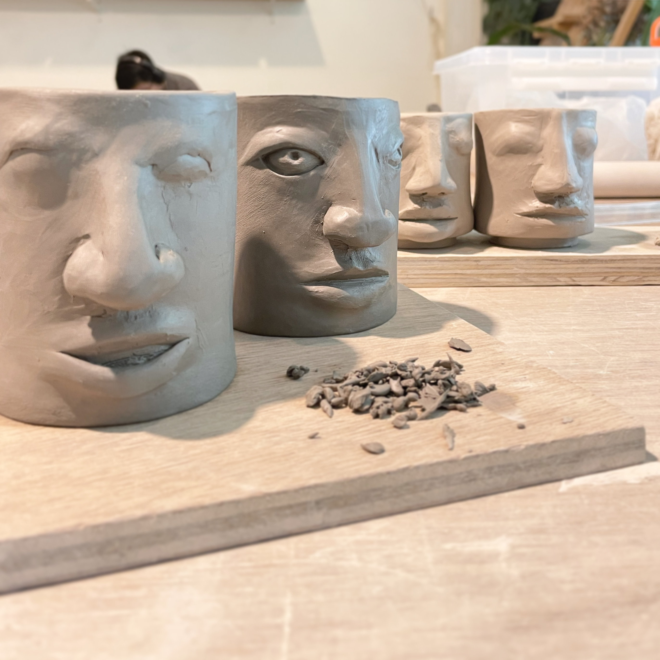 Two cup-shaped vessels with faces