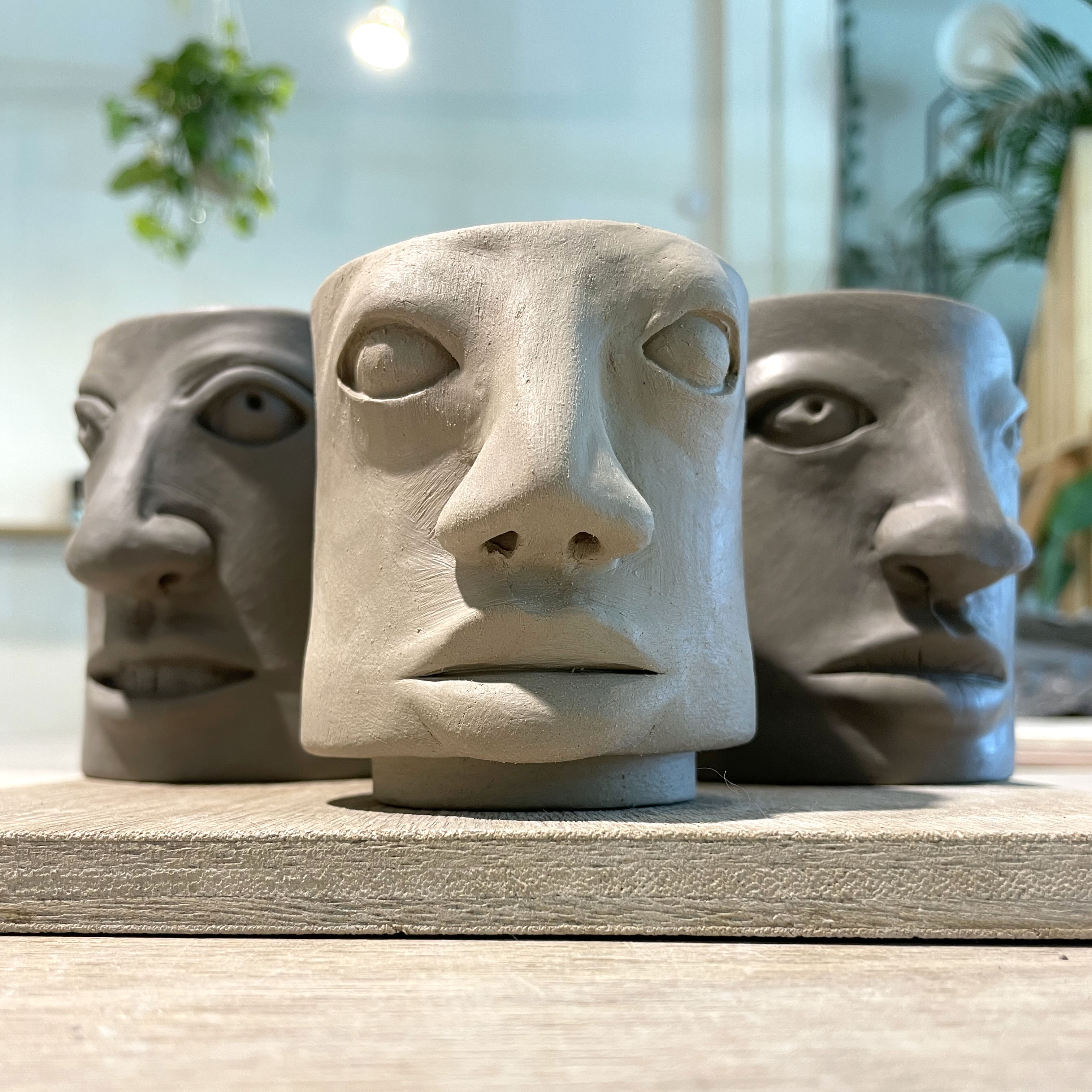 Three vessels with faces in the making